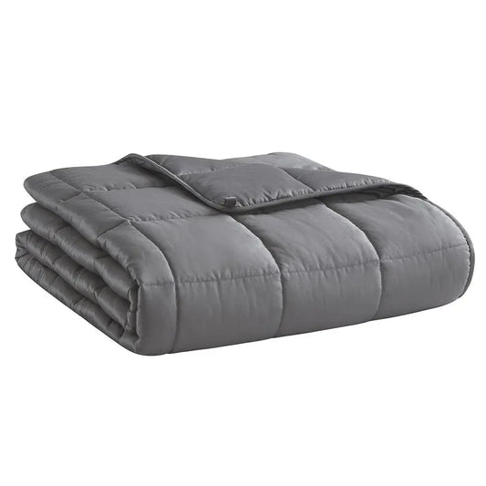 Folded gray weighted blanket on a white background